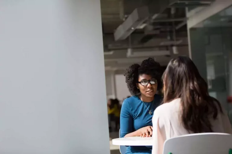 Two women meeting for public liability insurance mediation